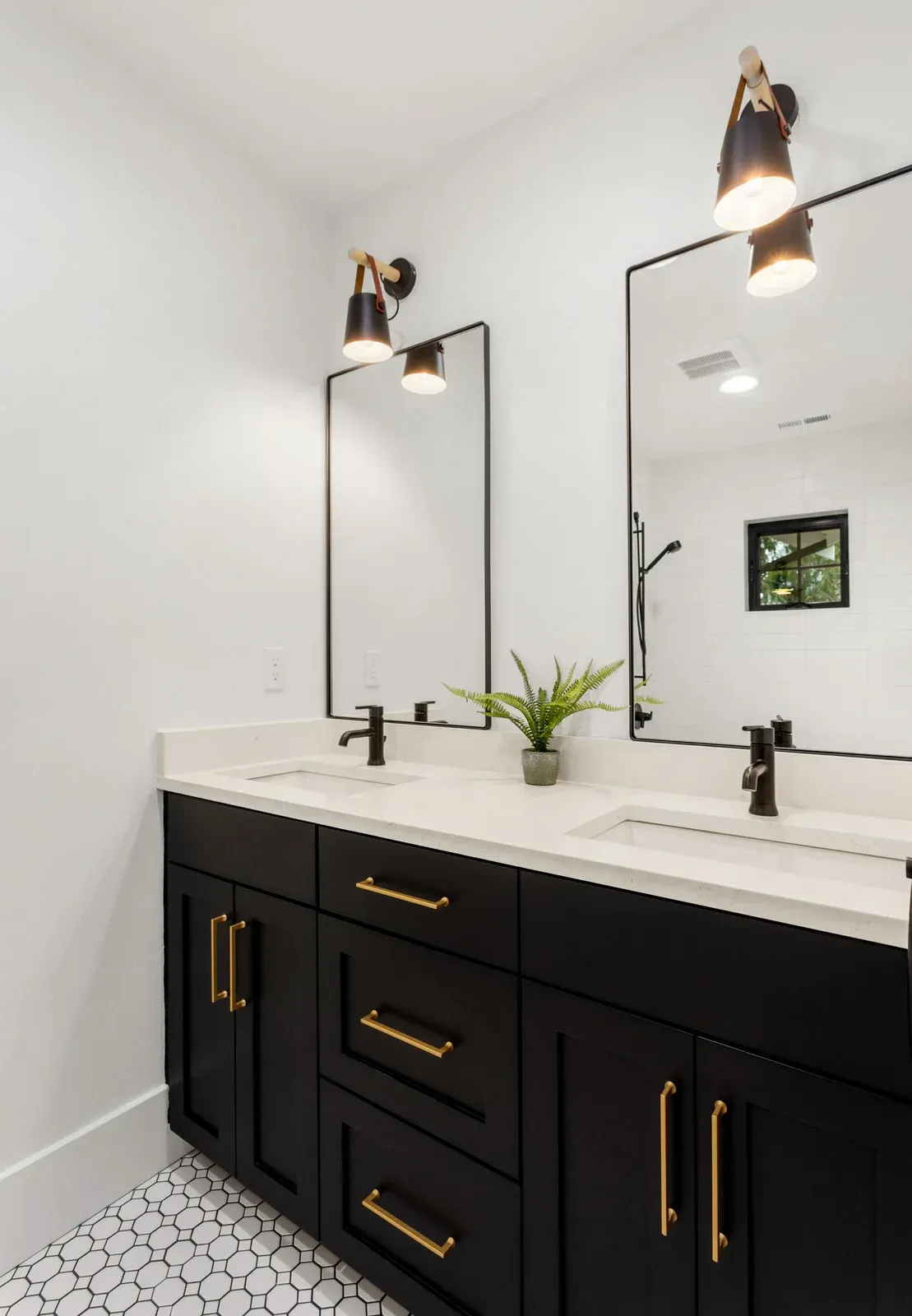 A bathroom with two sinks and two mirrors.