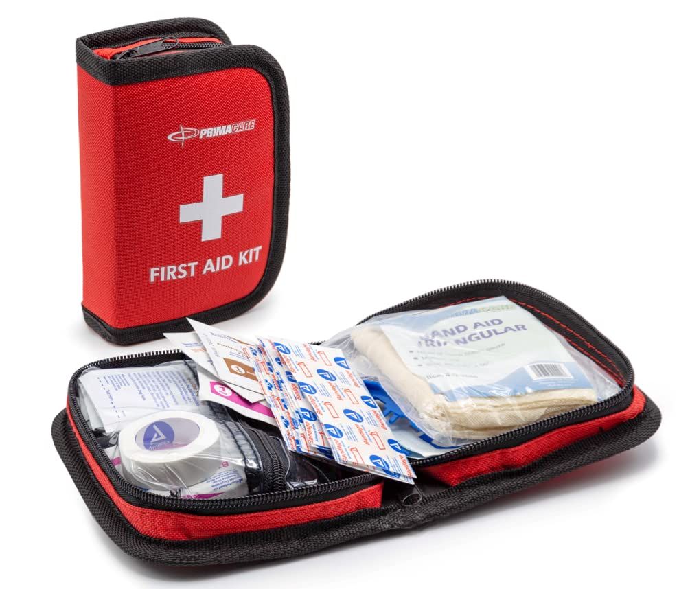 Red first aid kit open with bandages and medical supplies inside.