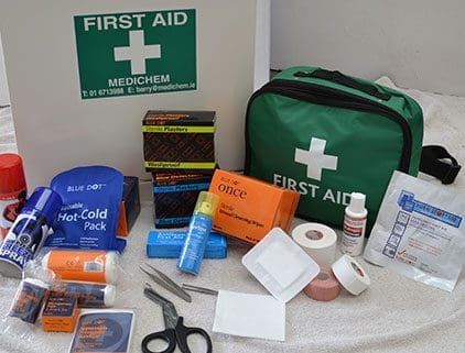 First aid kit and assorted medical supplies arranged on a table.