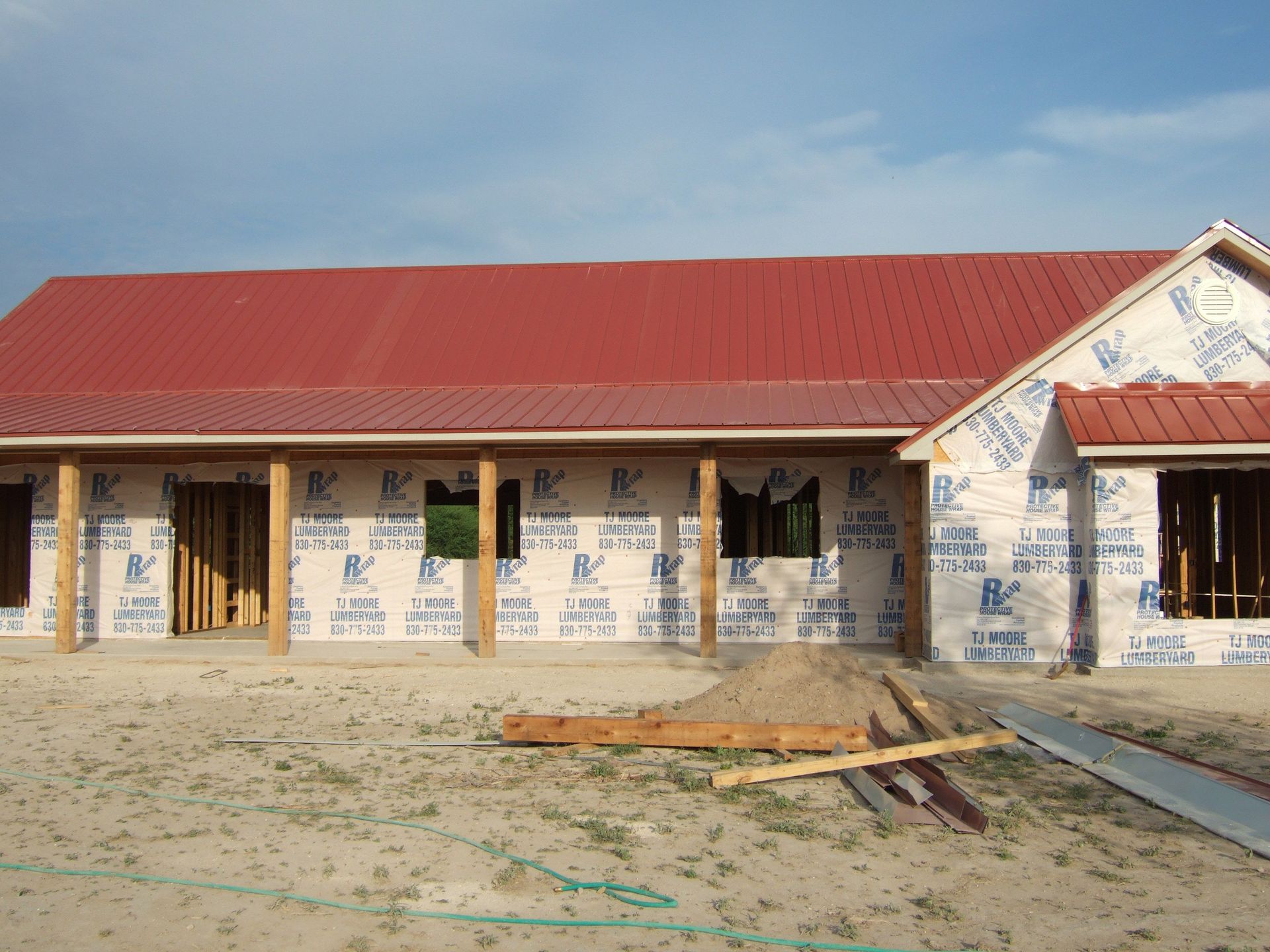 Red Standing Seam Metal Roof  by Austin Roofing and Construction 512-629-4949
