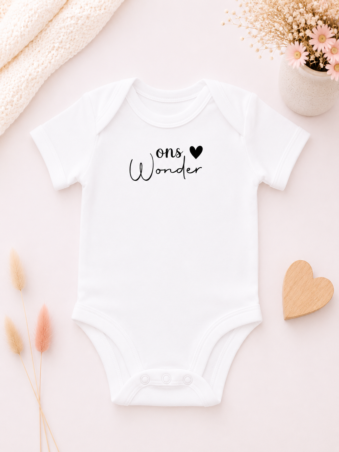 Wit babyrompertje met de tekst 'Ons Wonder' , persoonlijk bedrukt door Frantastisch DrukGeluk.