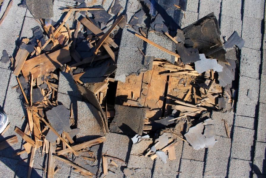 A Pile of Roof Shingles Laying on the Ground — Husky Demolition In Scone, NSW