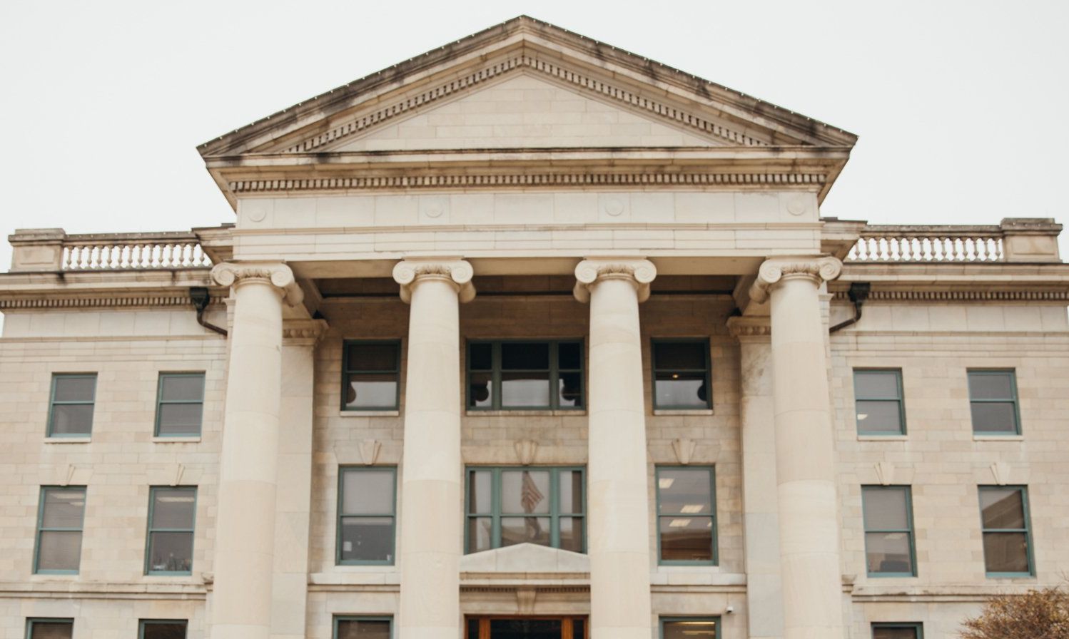 Entrance of Boone County Courthouse in Columbia, MO, Stone building with columns and pointed roof