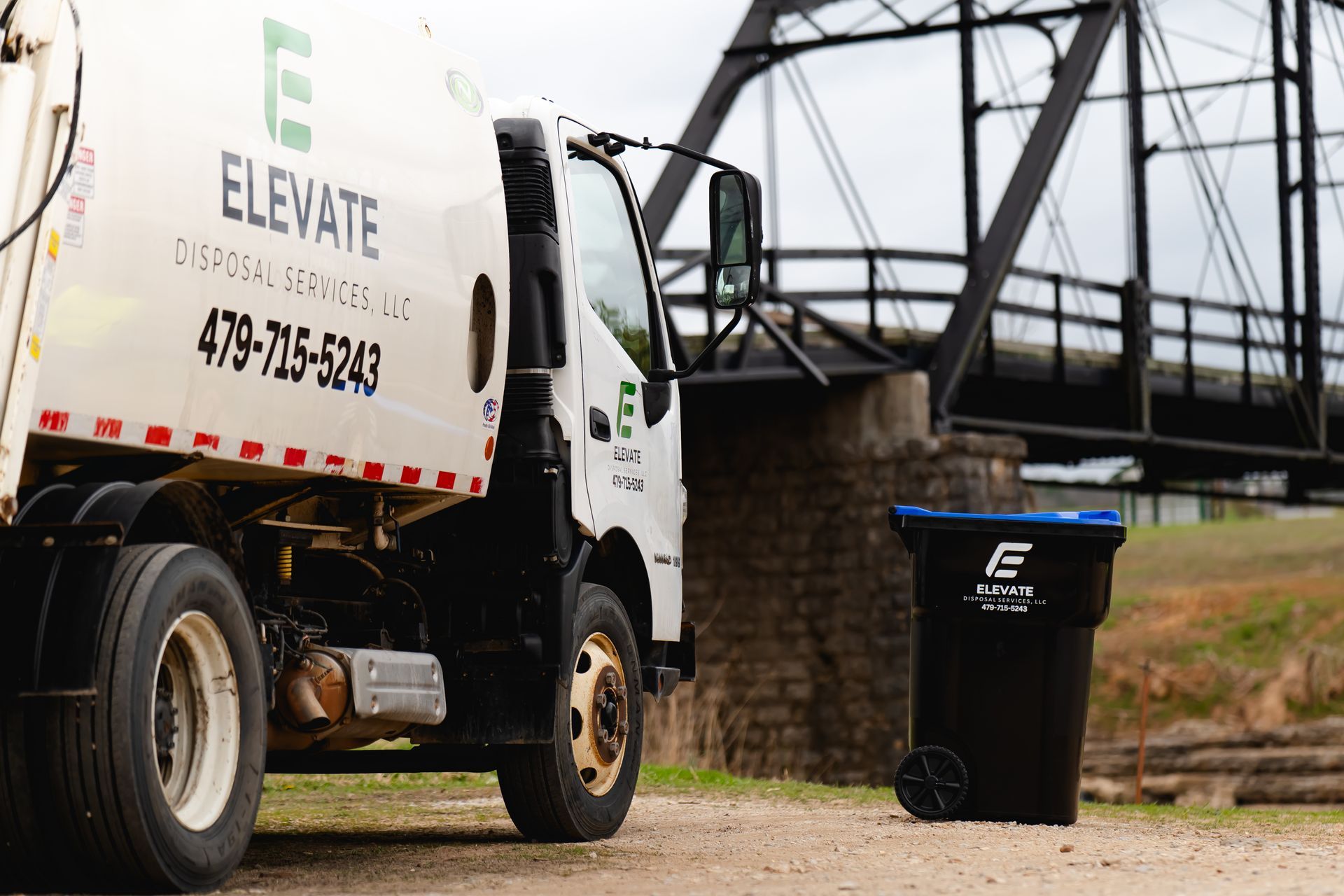 Elevate Disposal Services trash truck and a recycling bin