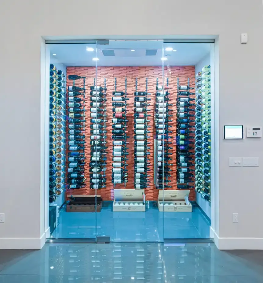 Modern wine cellar behind glass doors with wall-to-wall racks of bottles
