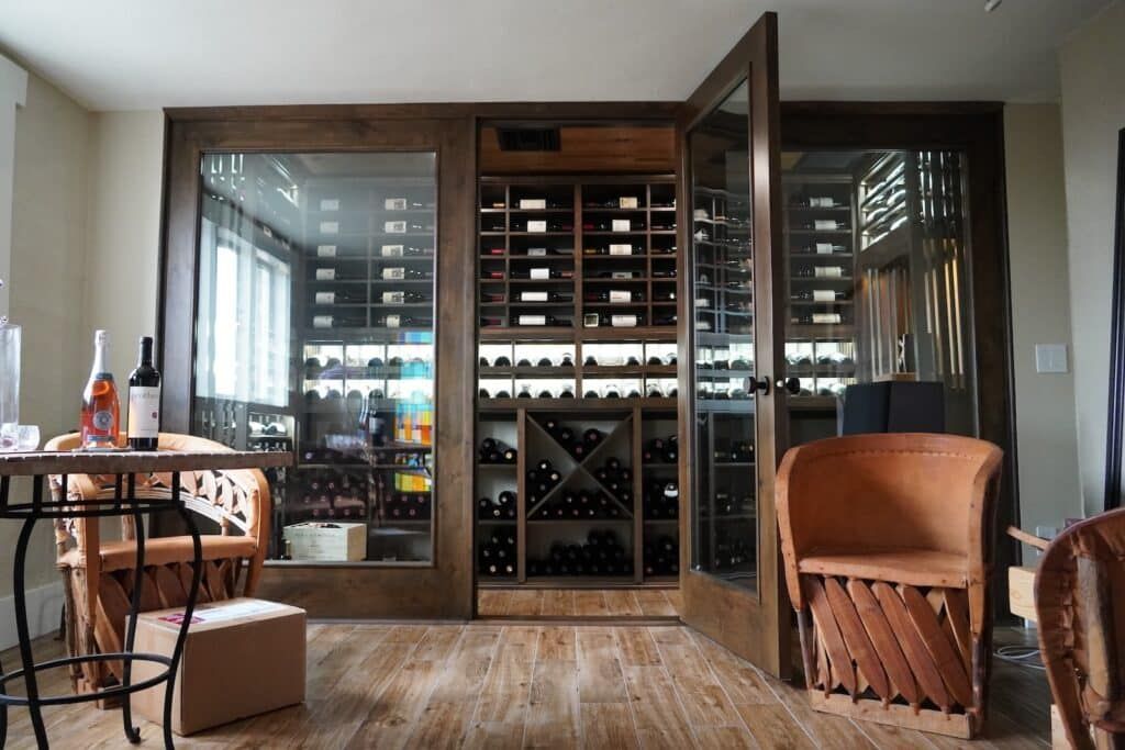 Wood-framed glass wine cellar doors set into an existing room opening