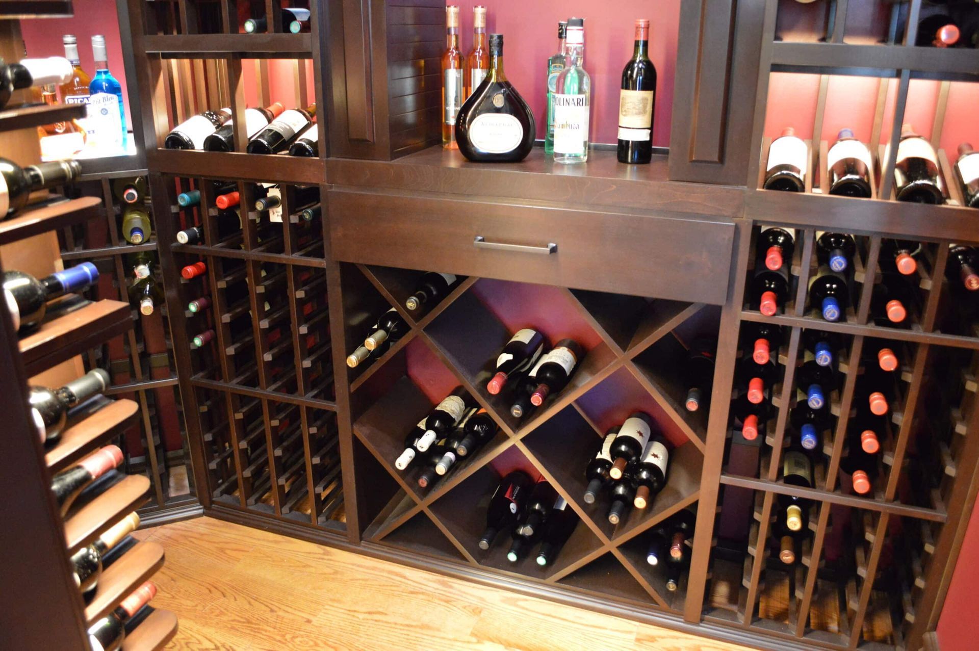 Wooden wine rack filled with bottles in a cozy cellar display