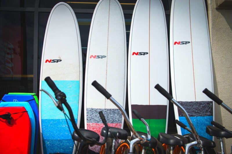 Four nsp surfboards are lined up next to each other