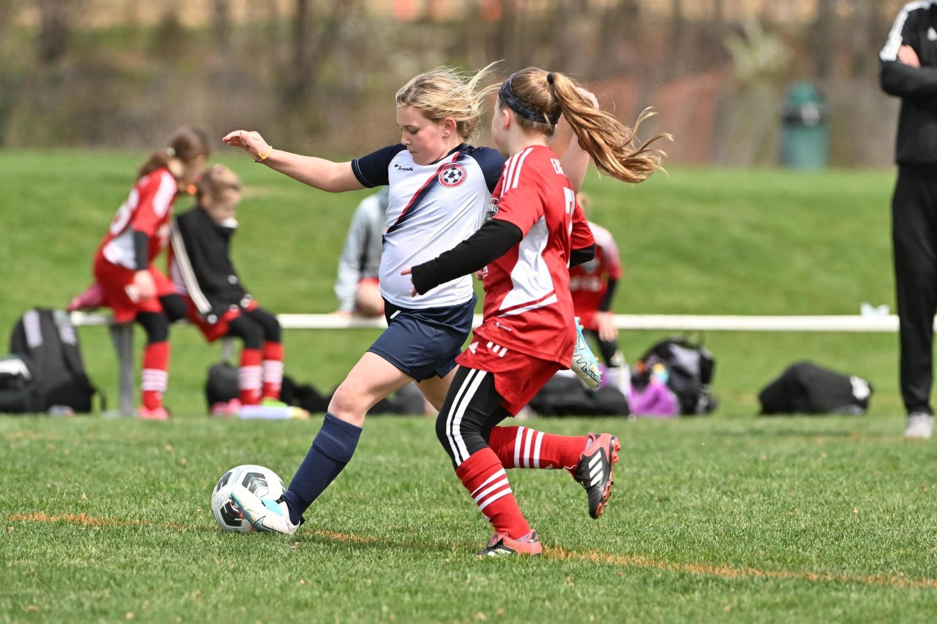 Clarke County Soccer League's female player taking a right footed shot at the top of the box.