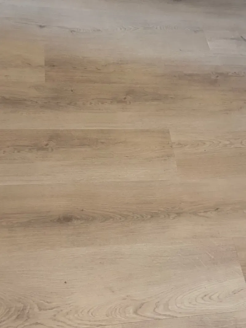 Light wood floorboards with a beige and gray grain pattern