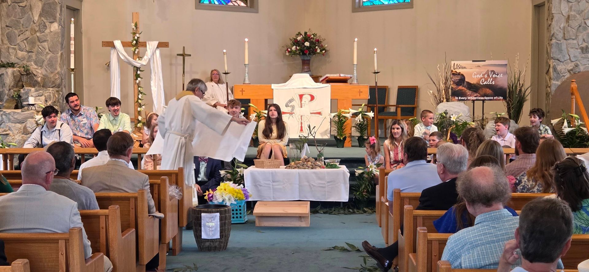 Church children's message with minister at altar and guests seated in pews