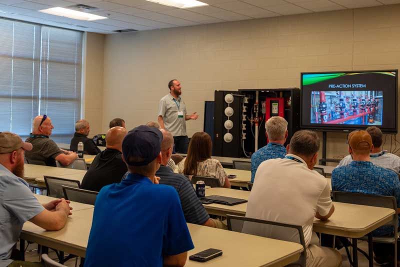 Instructor presents to class in a classroom. 