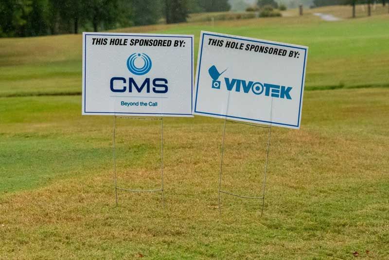 Two signs at a golf course.