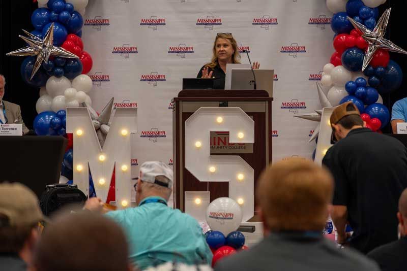 Woman speaking at podium.