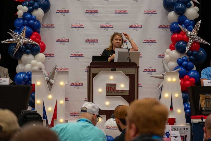 Woman speaking at a podium.