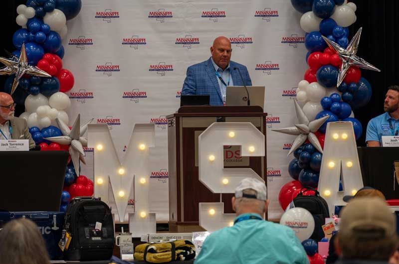 Man speaking at a podium.