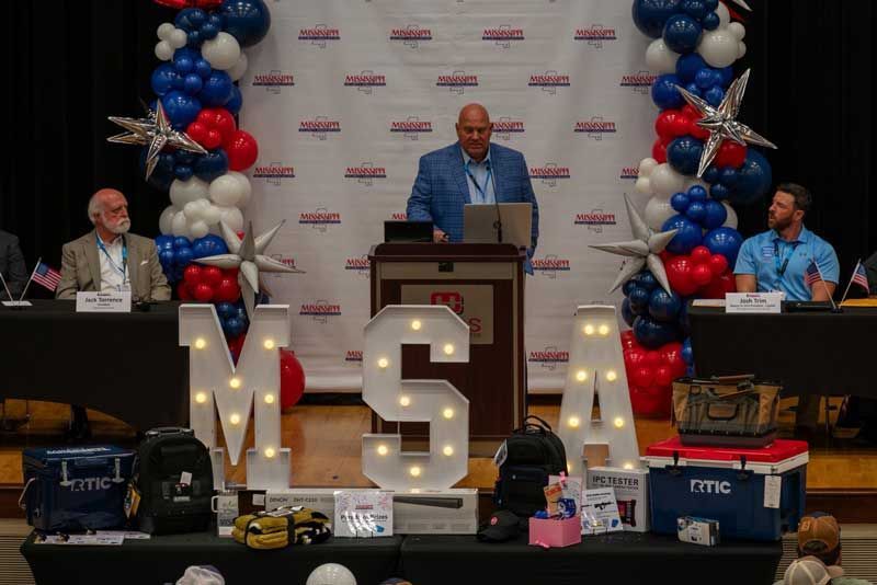 Man speaking at a podium with 