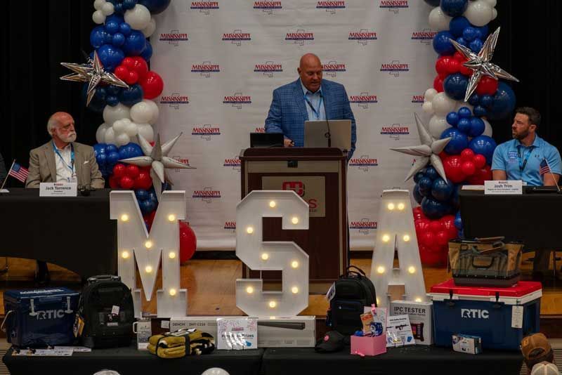 Man speaking at a podium with 