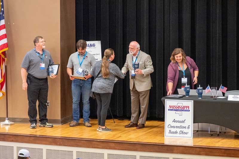 People on stage at an awards ceremony.