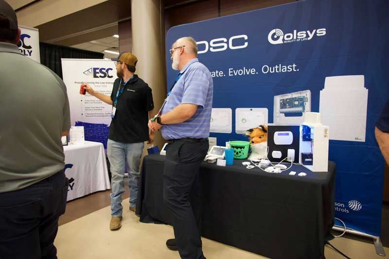 Two men at a trade show booth.