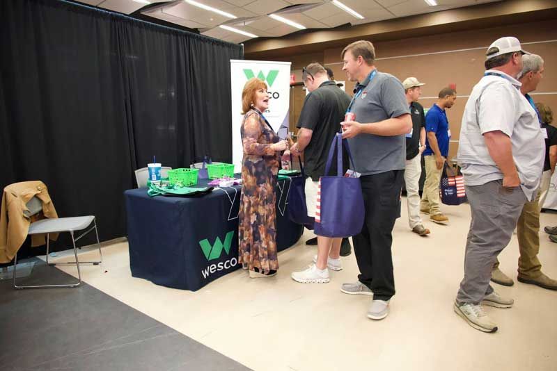People at a trade show booth.