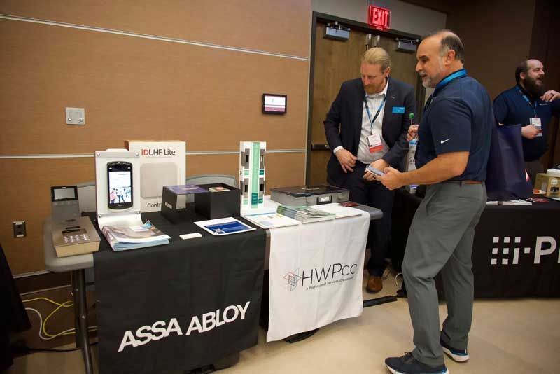 Two men at a trade show booth.