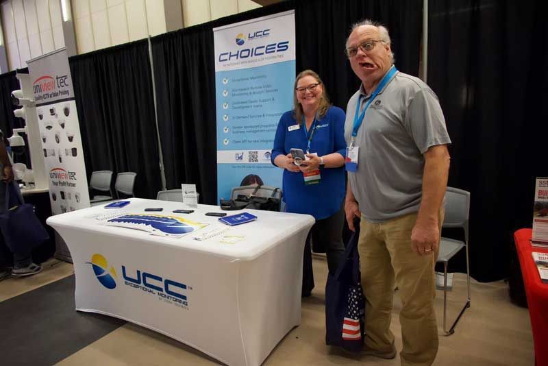 Two people at booth.