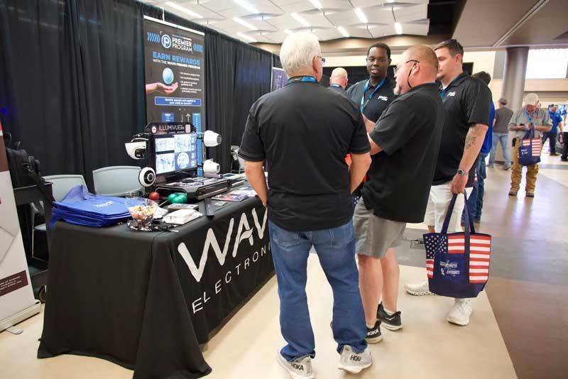 People at a trade show booth.