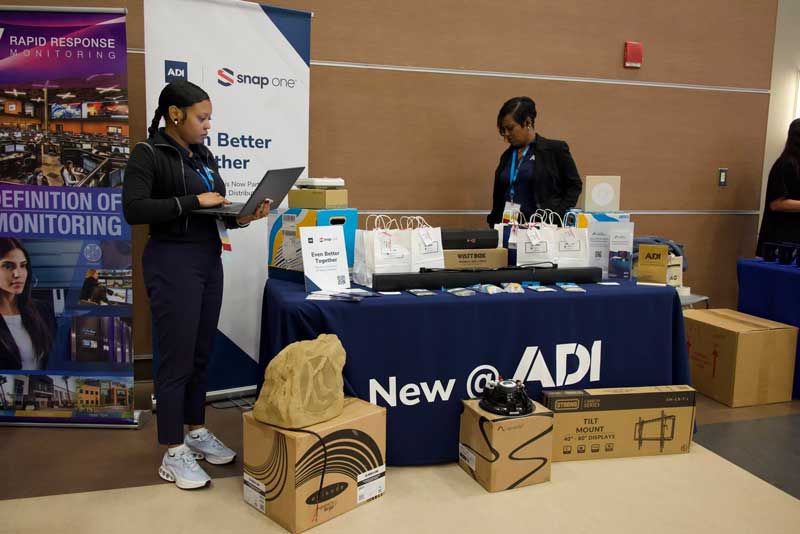 Two people at a trade show booth.