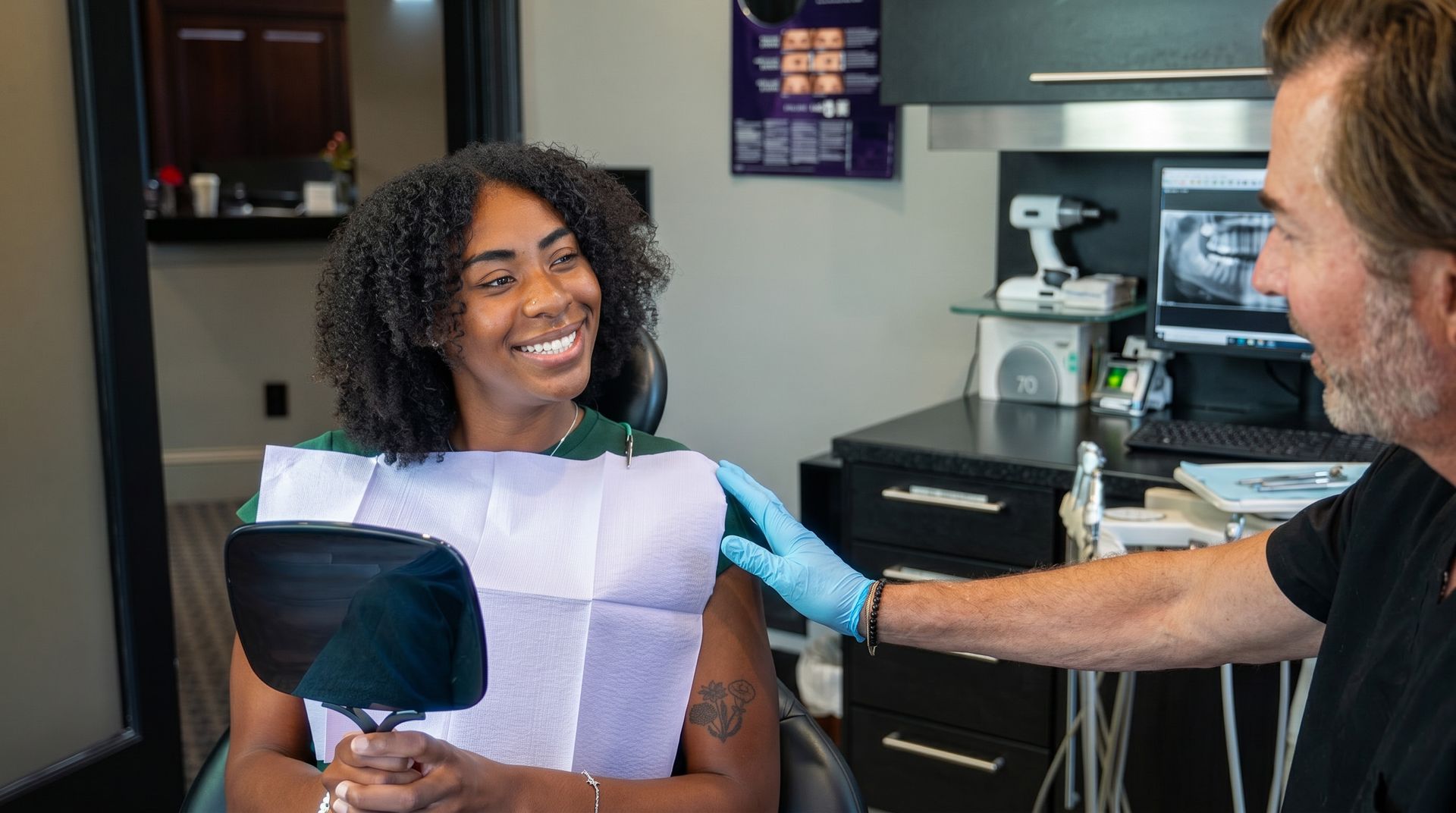 Smiling woman receiving an eye exam from a clinician in a medical office