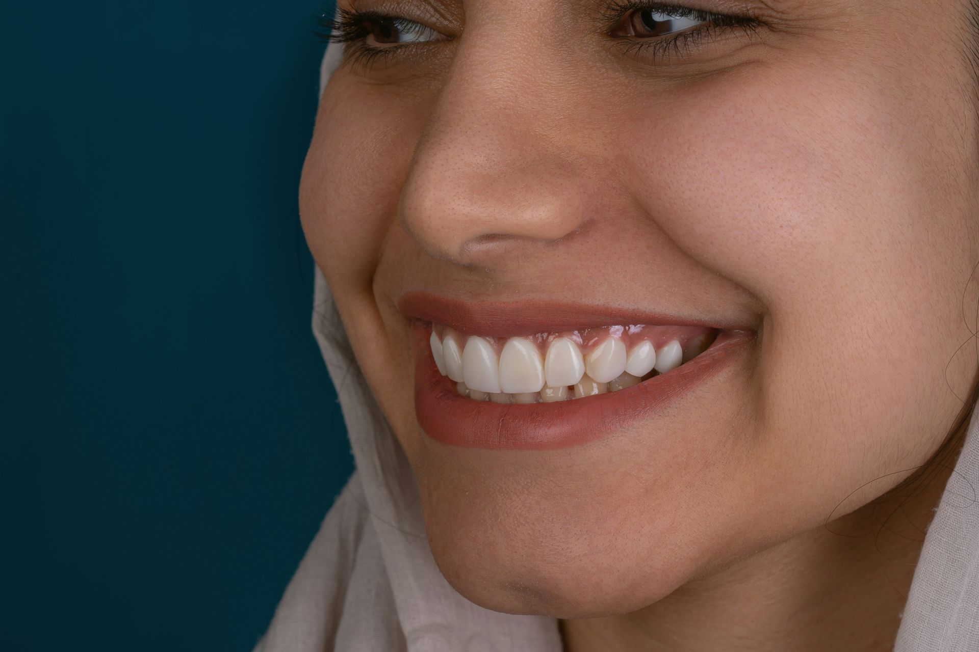 Close-up of a smiling person showing white teeth.