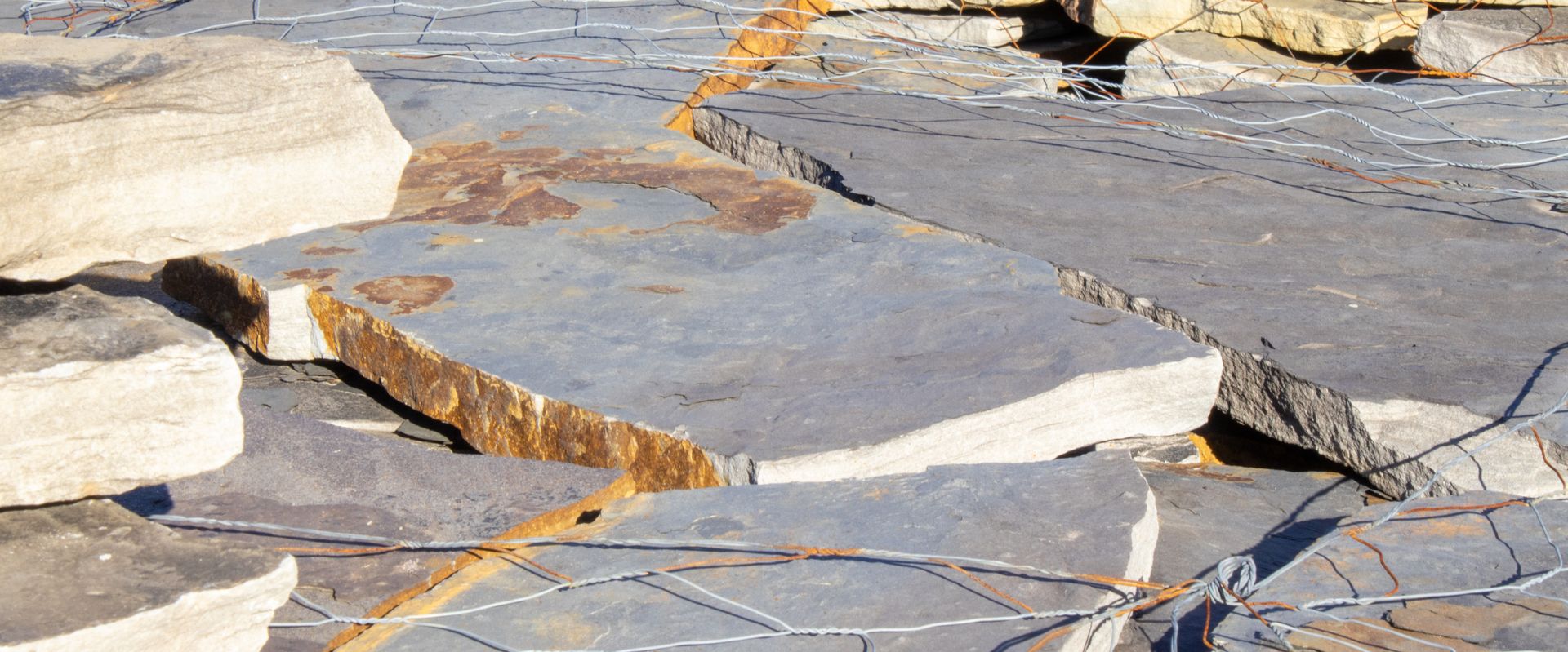 A pile of rocks sitting on top of each other on a concrete surface.
