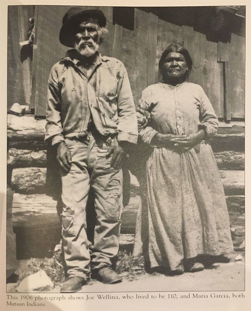 A black and white photo of a man and woman standing next to each other