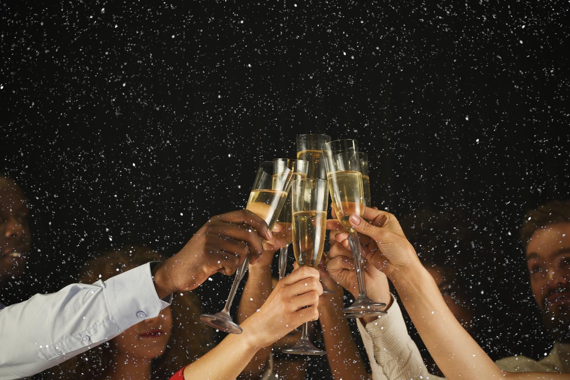A group of people are toasting with champagne glasses