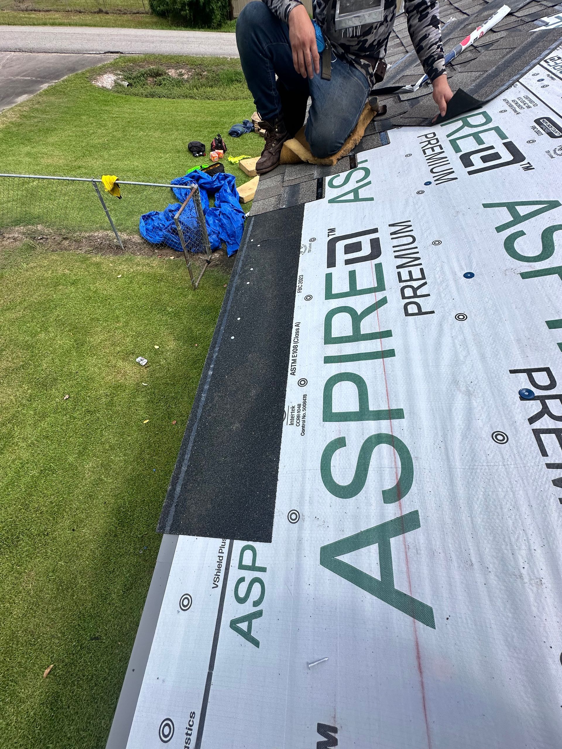 Roofer installing roofing material on a house. Asphalt shingle on a roof with 