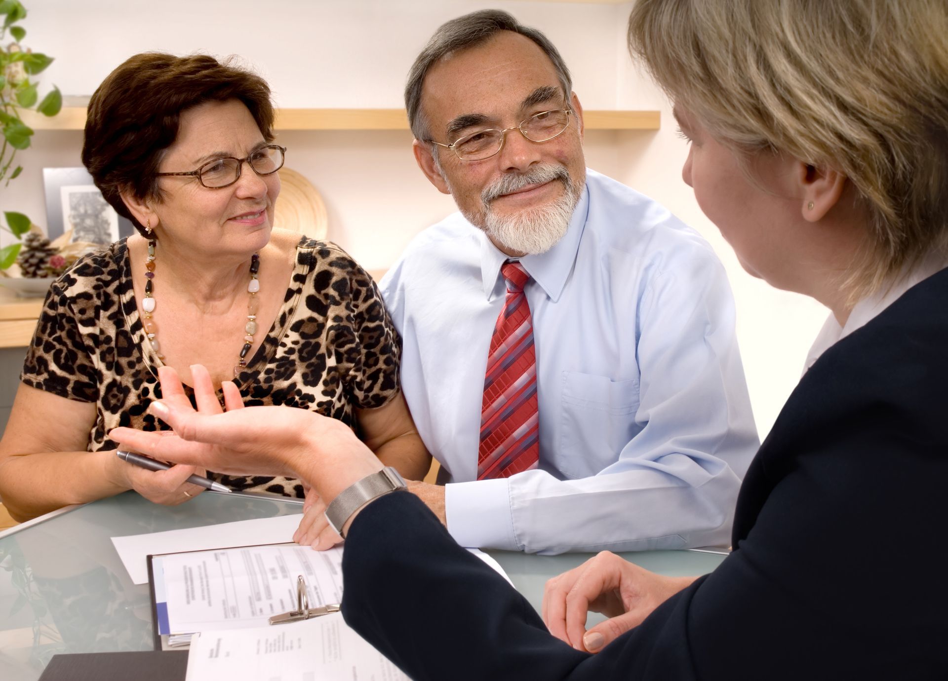A senior couple is talking with a lawyer. A senior couple is talking with a lawyer.