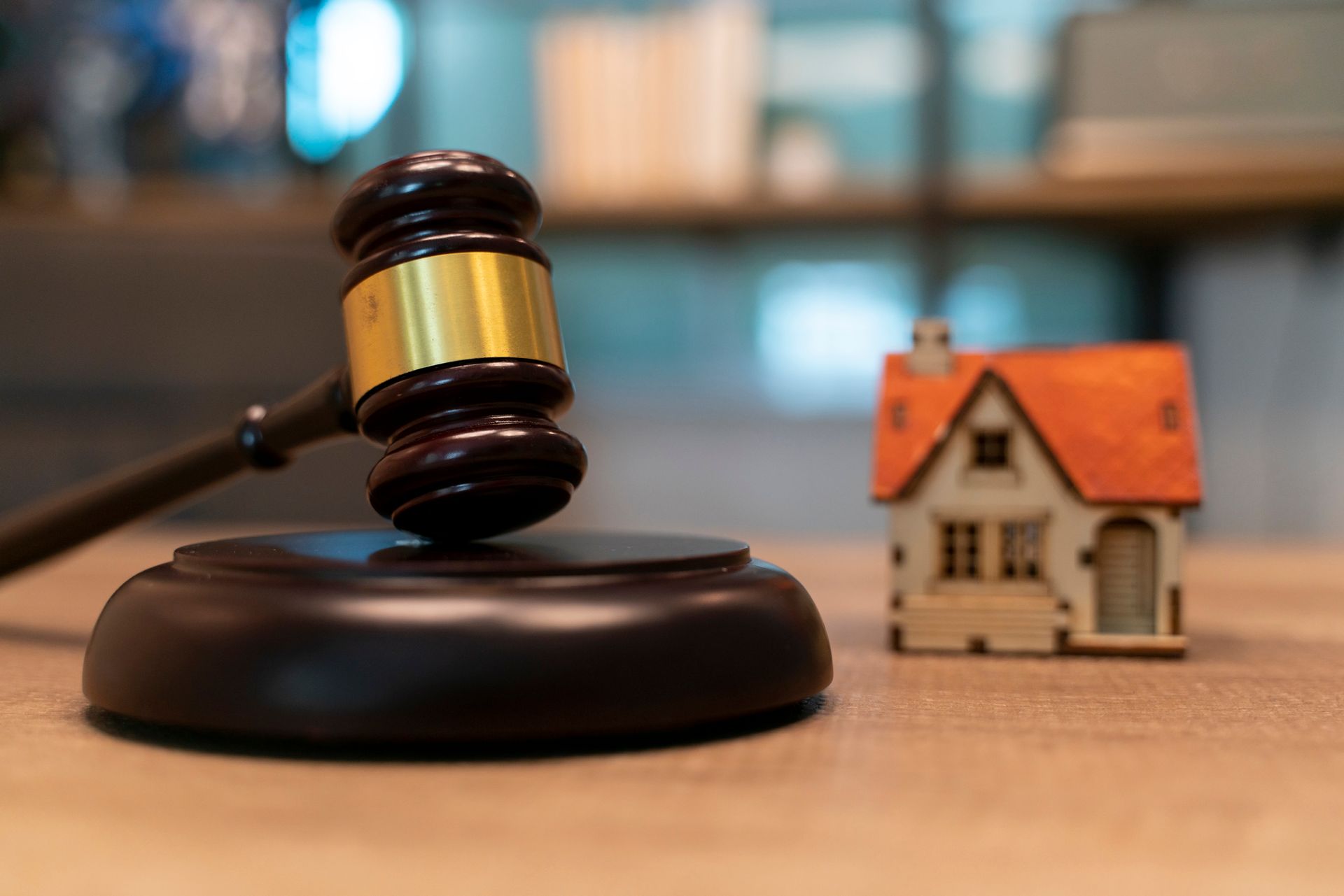 Gavel and toy house.
