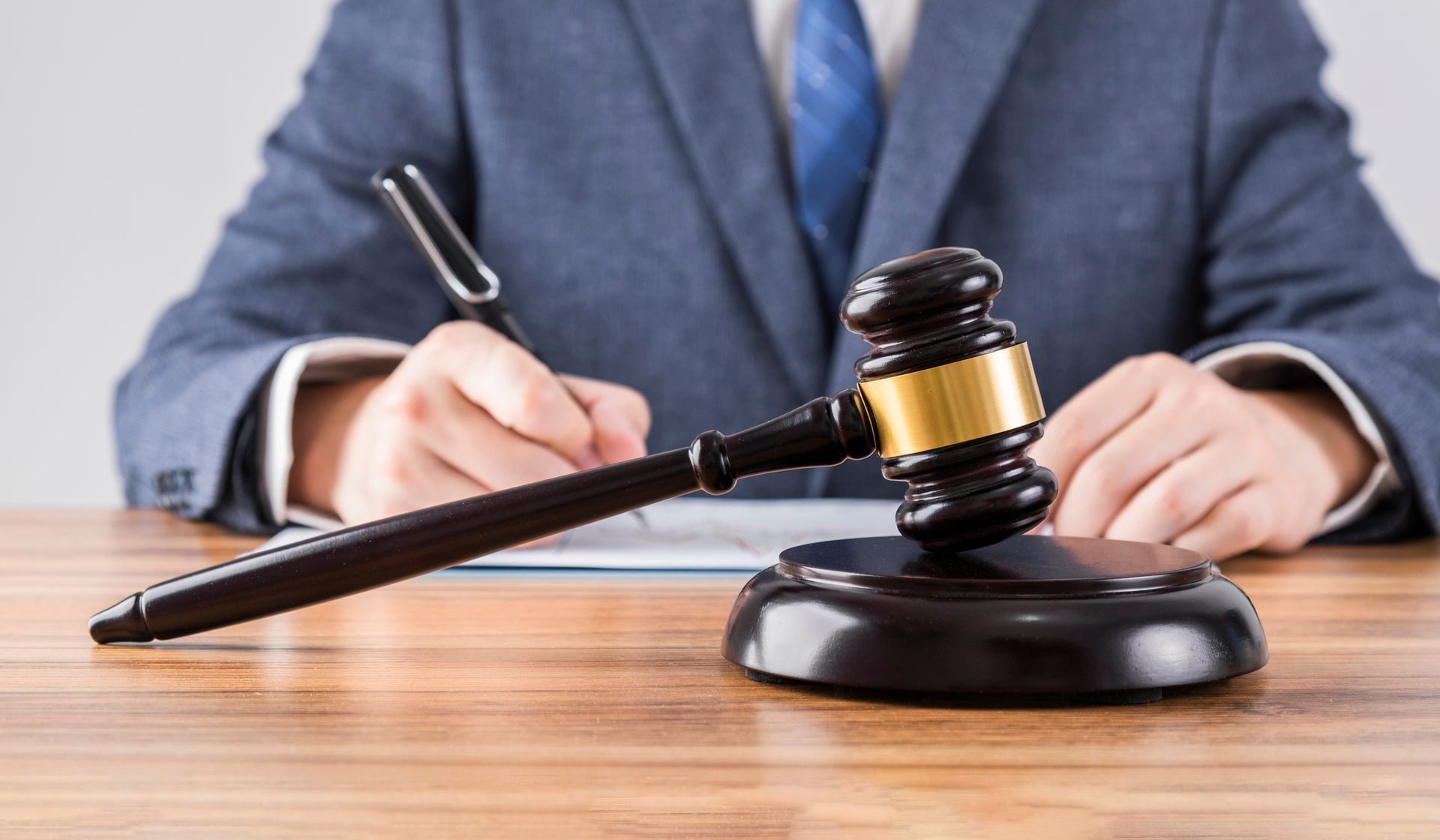 Gavel on a wooden desk.
