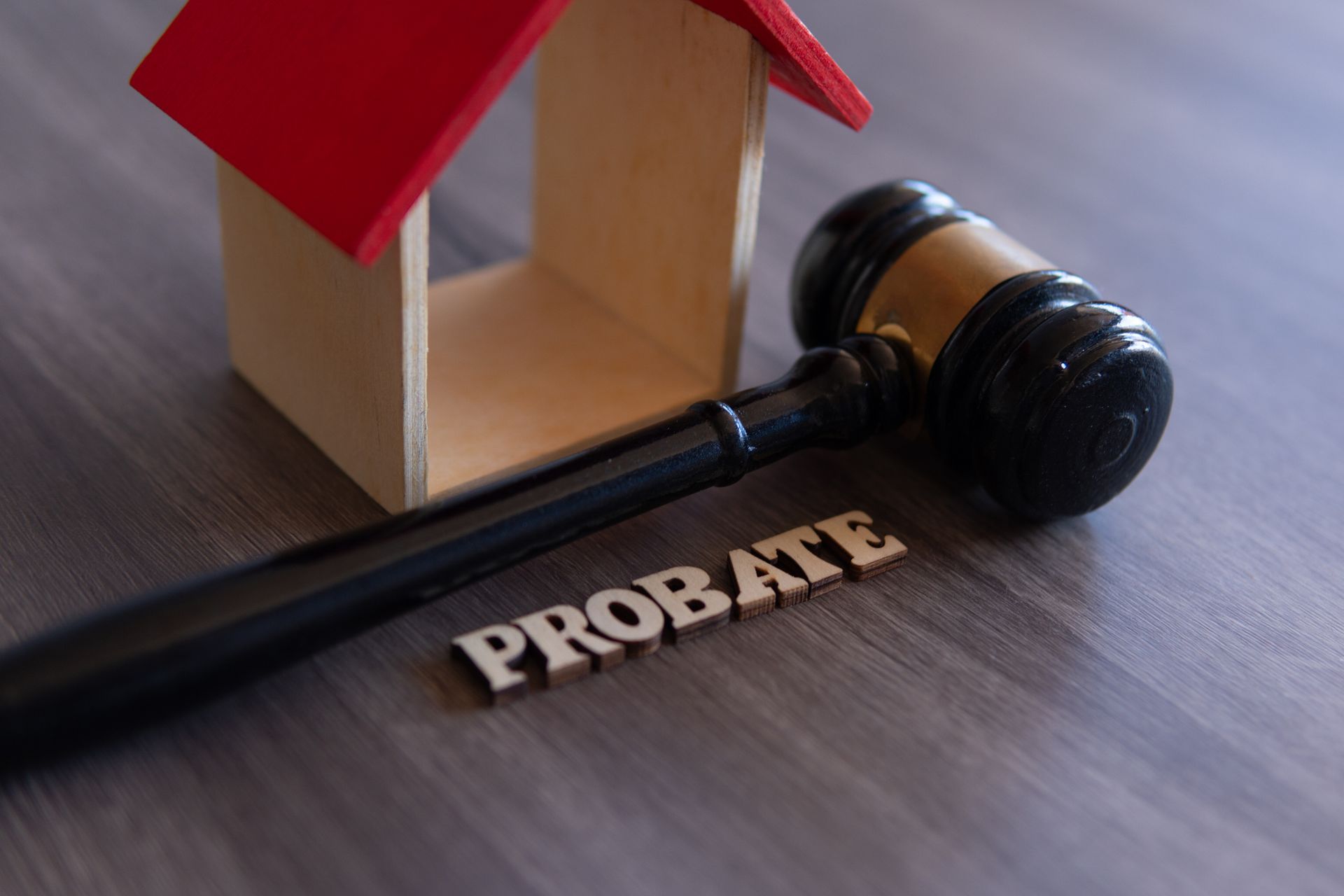 Wooden house model, gavel, and