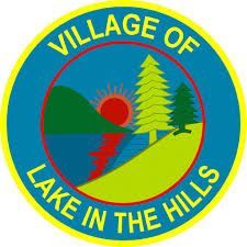 Village of Lake in the Hills logo. Features a lake, sun, trees, and hills in a blue, green, and yellow circular design.