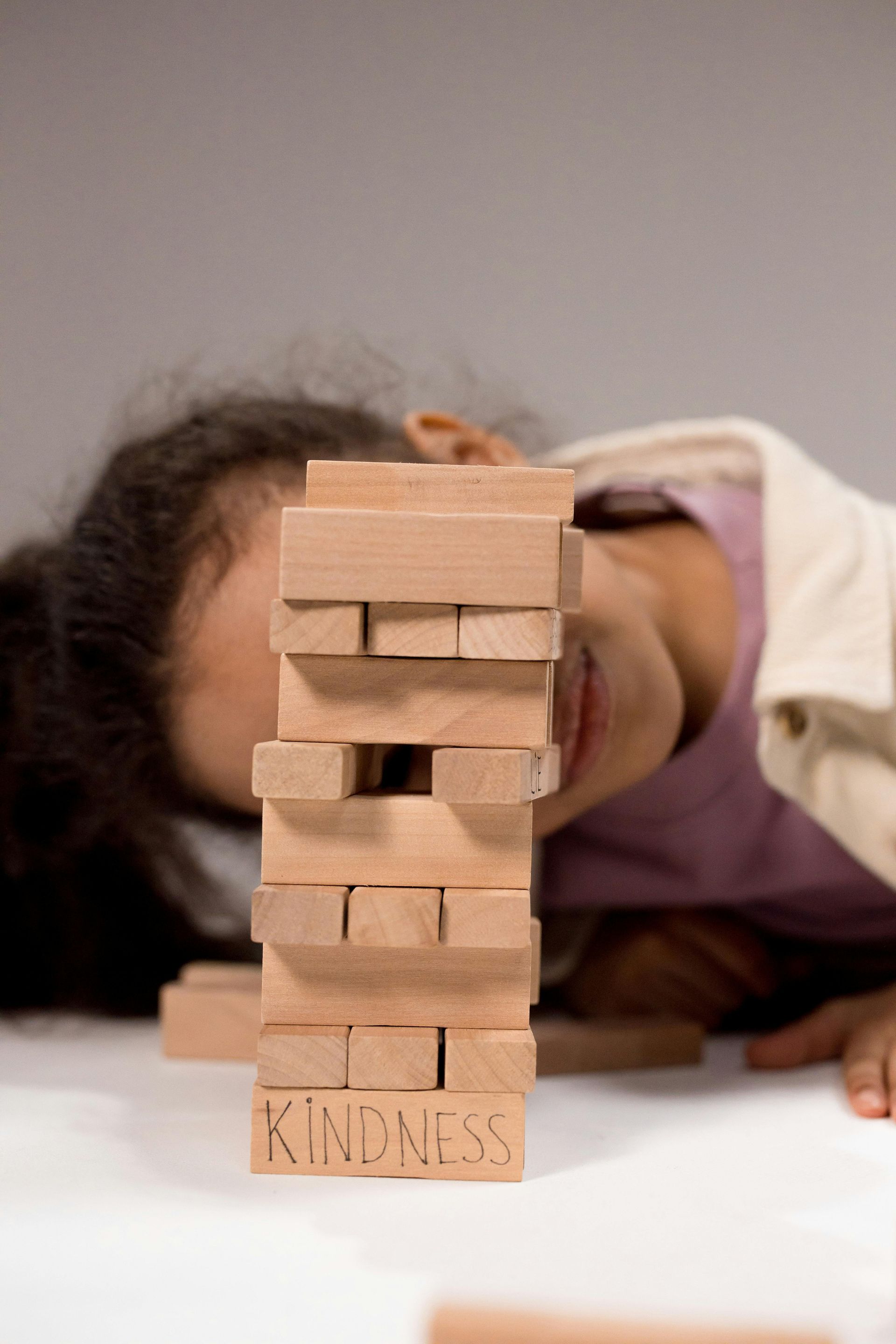 Child playing Jenga with 