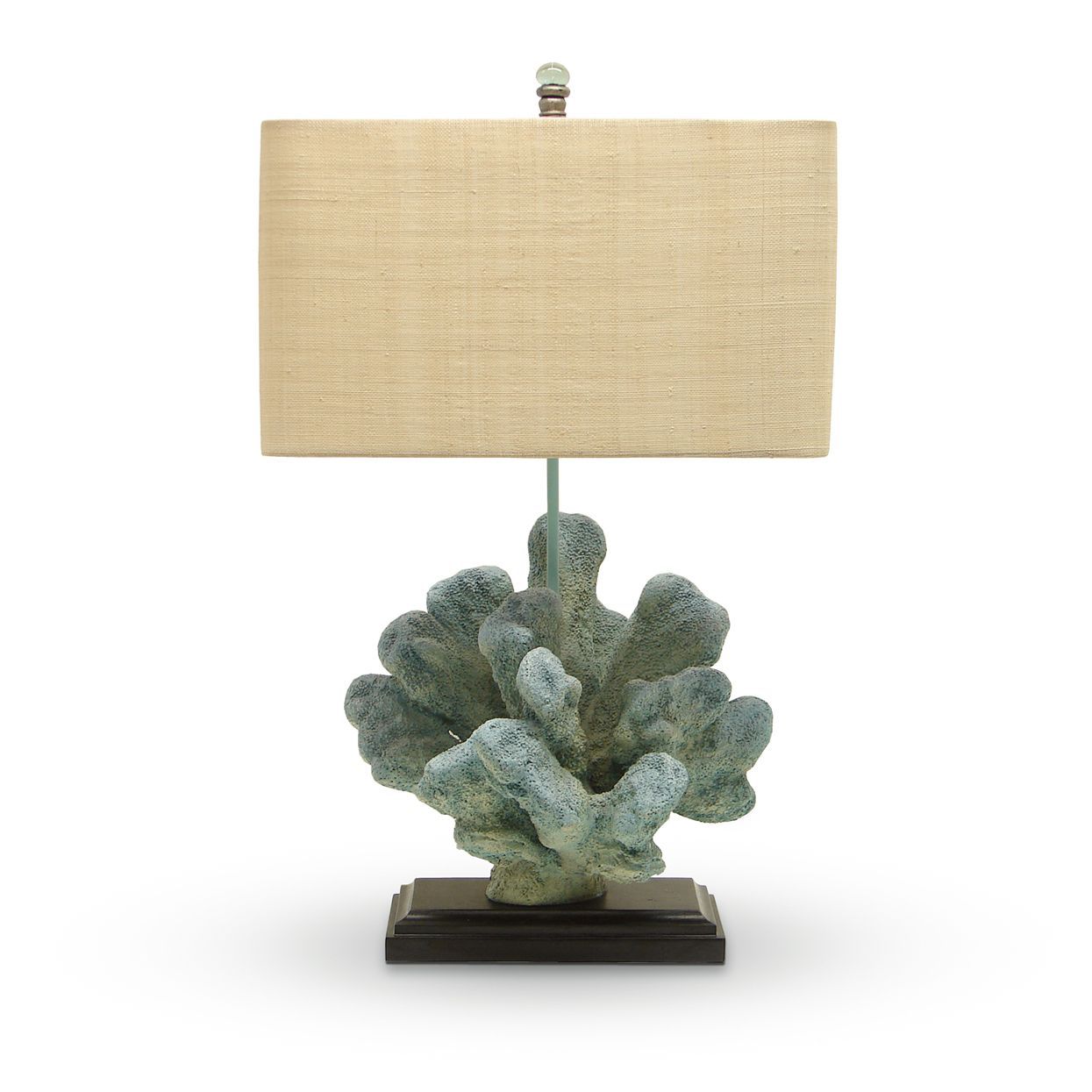Table lamp with beige rectangular shade and coral-shaped blue-green base on a dark stand