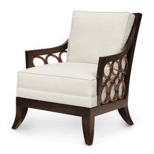 White upholstered armchair with dark wood frame and circular side cutouts