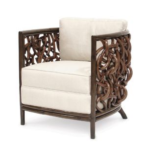 Cream upholstered armchair with carved dark wood frame and decorative side panels