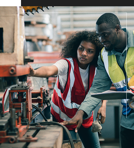 Man and women working on machine