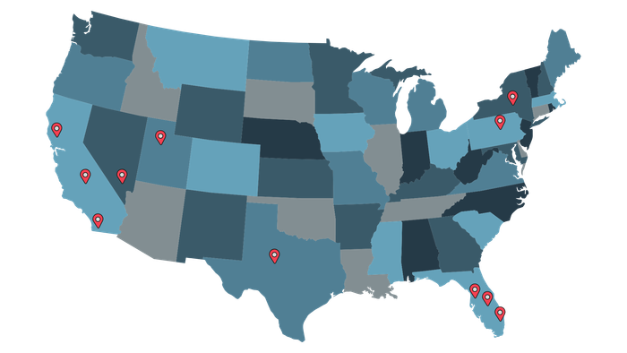 Map of the United States with several red location markers on a blue-gray choropleth background