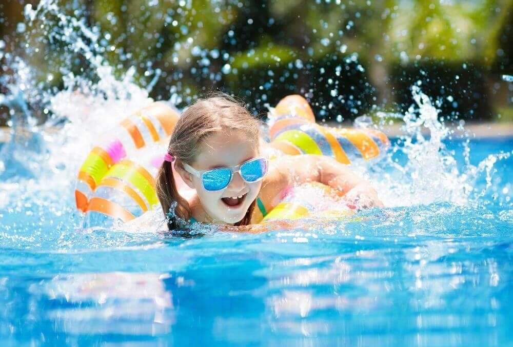 Child happy playing in the pool