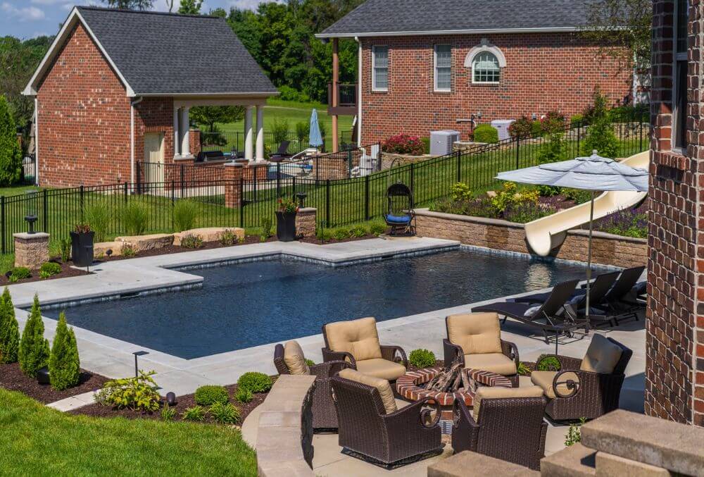 Classic residential pool with slide and fire pit