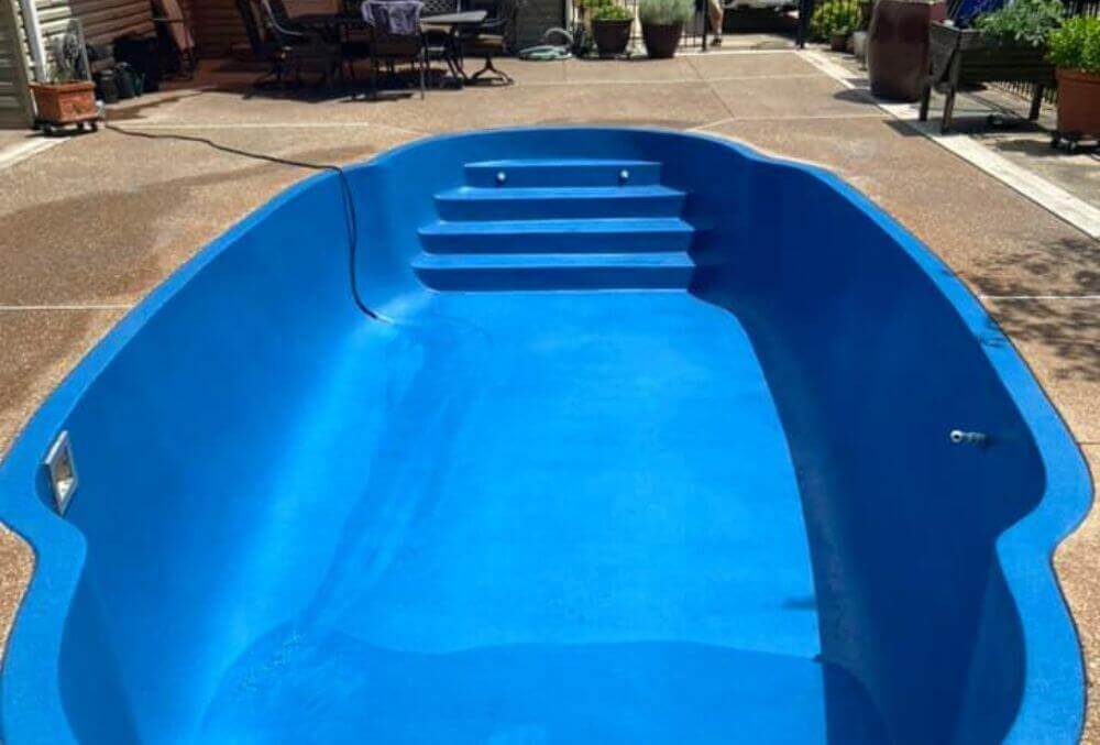 Empty inground swimming pool under maintenance