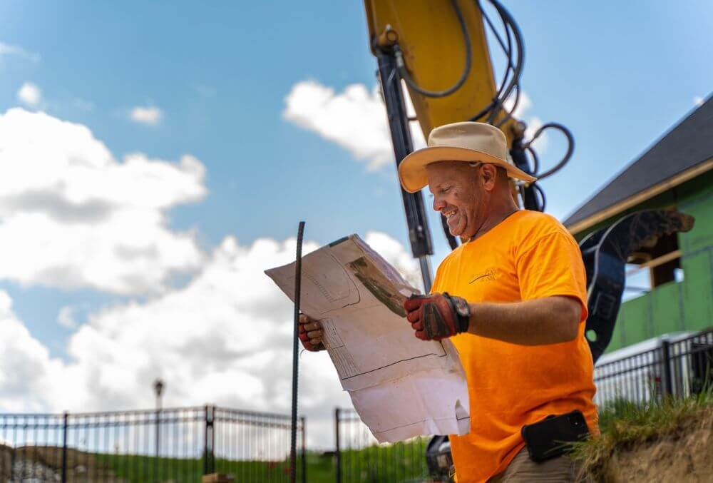 Heintz pool & spa employee looking at pool blueprint for building